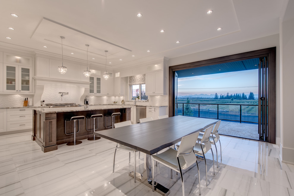 Large transitional u-shaped kitchen pantry in Vancouver with white floor, an undermount sink, recessed-panel cabinets, yellow cabinets, granite benchtops, white splashback, stone slab splashback, stainless steel appliances, porcelain floors and with island.