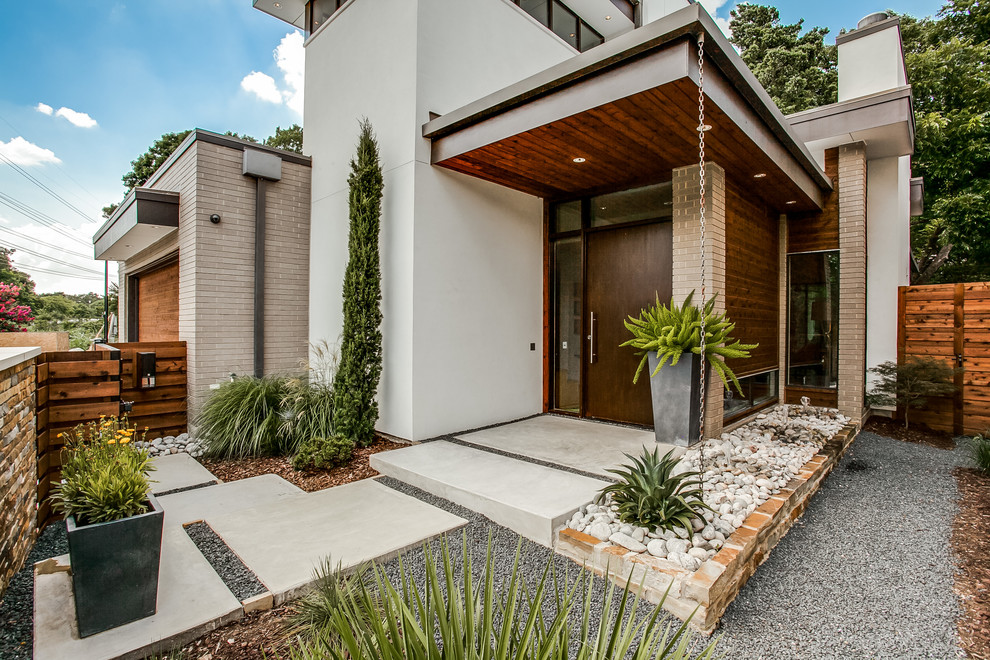 This is an example of a large contemporary front door in Dallas with concrete floors, a single front door and a brown front door.
