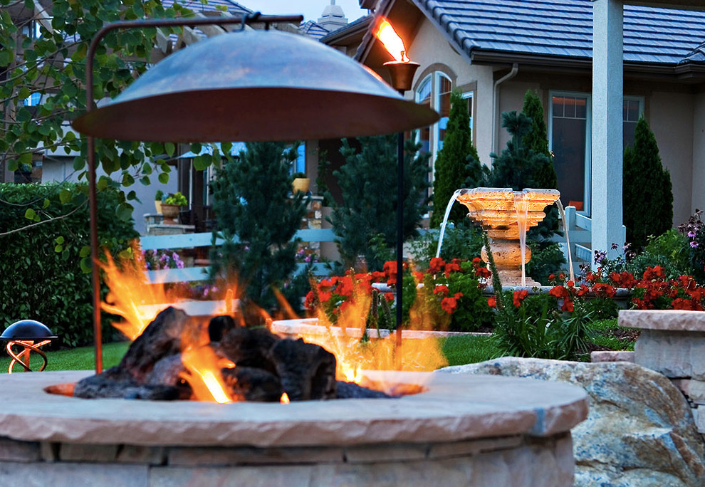 Inspiration for a mid-sized transitional full sun backyard stone water fountain landscape in Denver for spring.