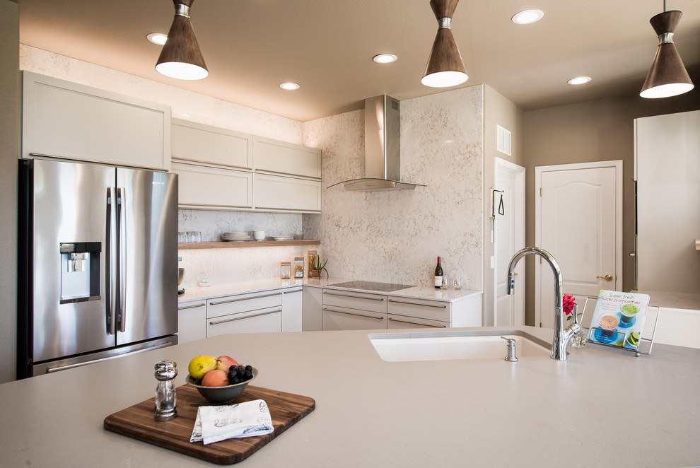 Inspiration for a mid-sized contemporary l-shaped open plan kitchen in Denver with an undermount sink, shaker cabinets, white cabinets, quartz benchtops, white splashback, stone slab splashback, stainless steel appliances, medium hardwood floors, with island and brown floor.