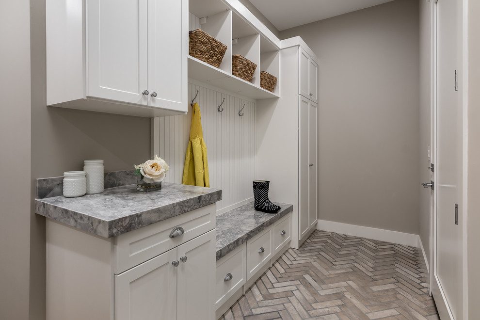 Design ideas for a transitional mudroom in Phoenix with grey walls, a single front door, a white front door and grey floor.