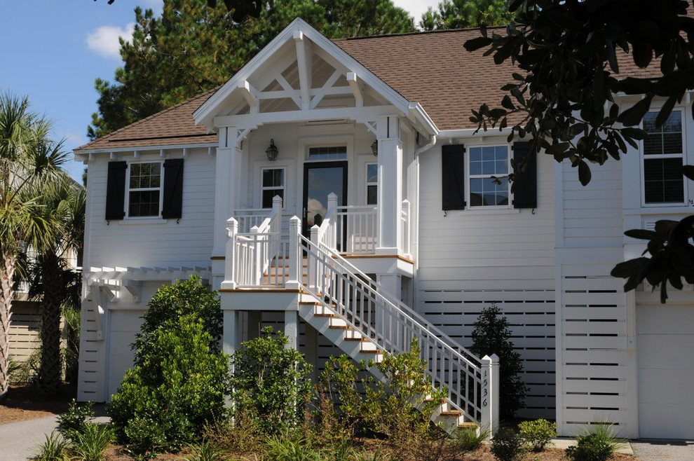 Mid-sized traditional two-storey white exterior in Charleston with wood siding and a hip roof.