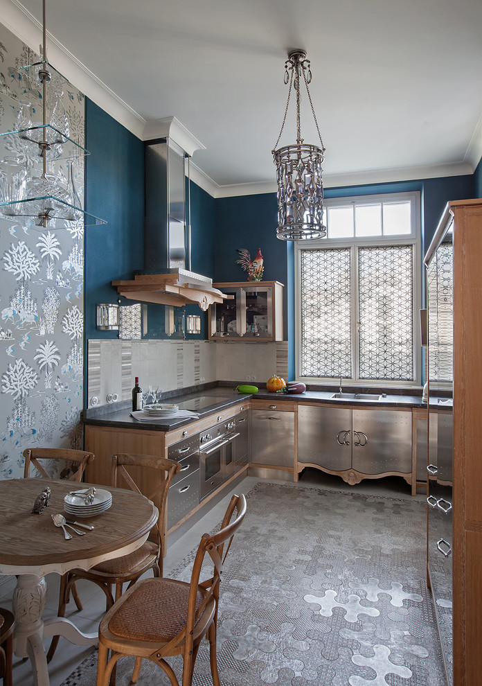 Photo of a mid-sized eclectic l-shaped separate kitchen in Moscow with flat-panel cabinets, stainless steel cabinets, grey splashback, stainless steel appliances, an undermount sink, stone tile splashback, marble floors and no island.