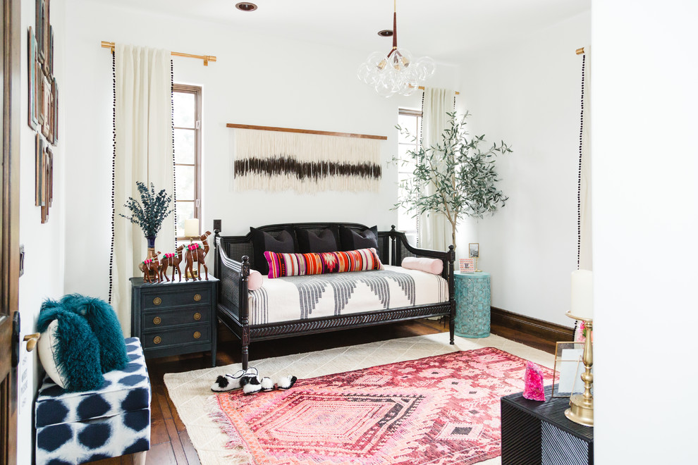 Inspiration for a large eclectic guest bedroom in San Diego with white walls, dark hardwood floors, no fireplace and brown floor.