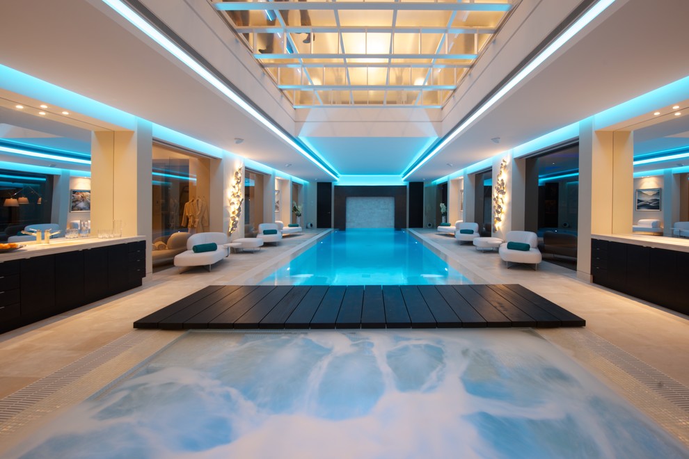 Photo of a mid-sized contemporary indoor rectangular pool in Other with a pool house and tile.