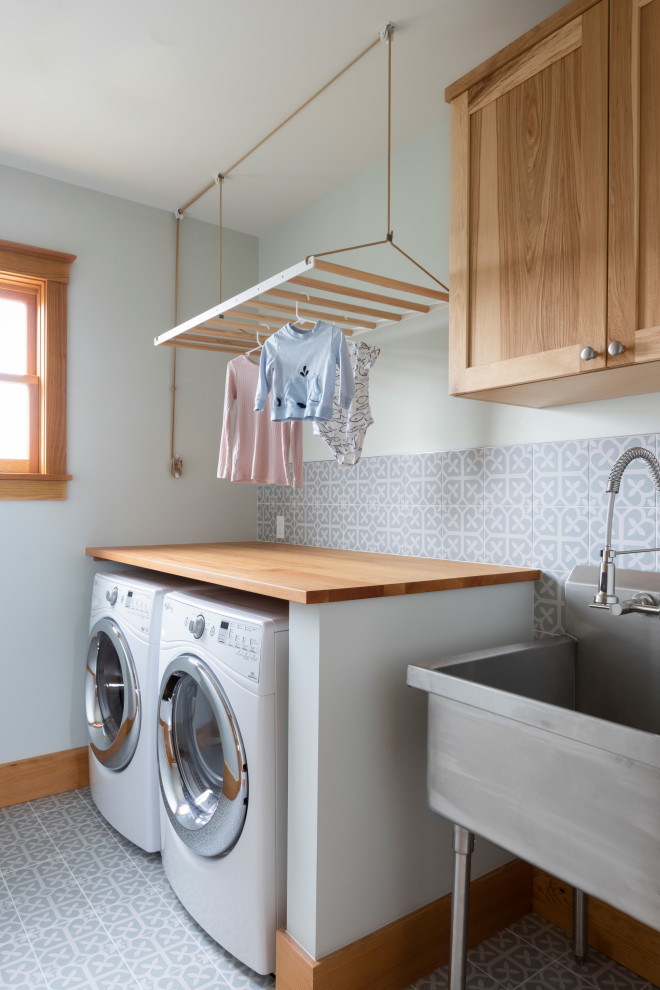 Example of a transitional laundry room design in Seattle