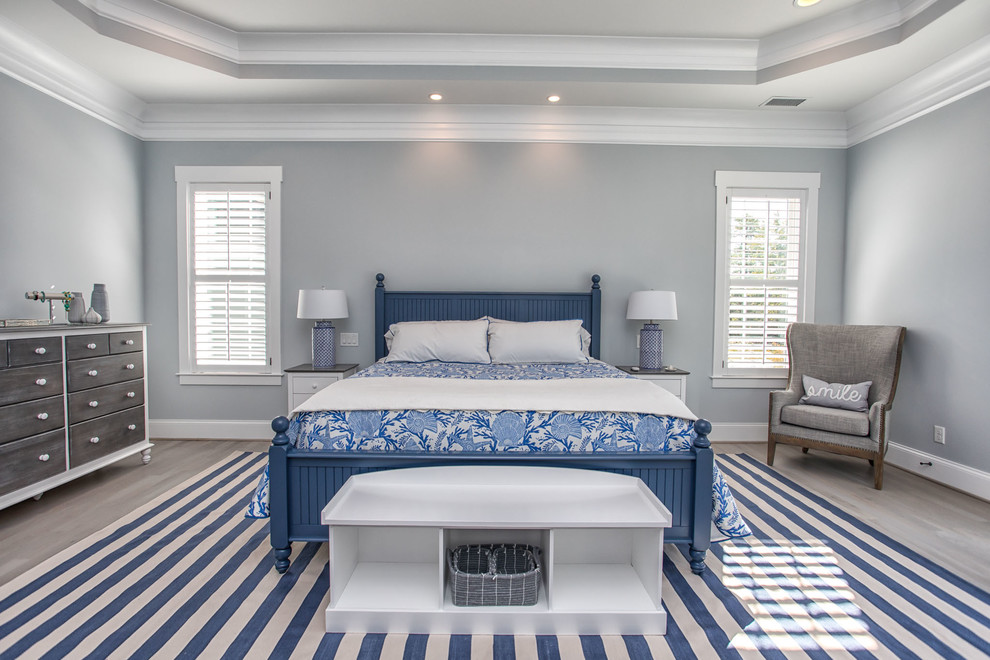 This is an example of a beach style master bedroom in Wilmington.