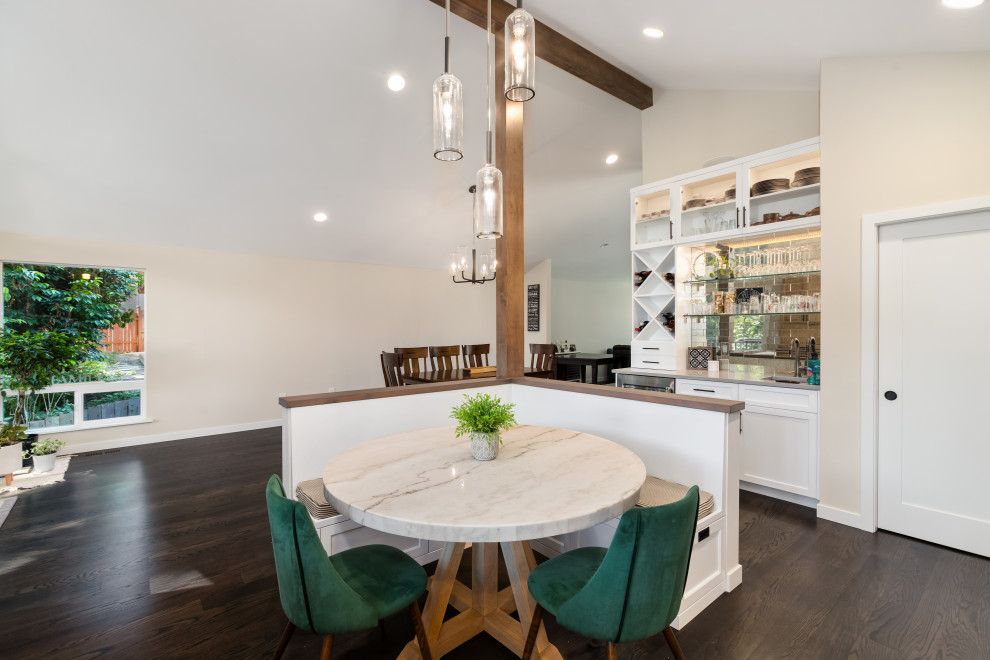 Design ideas for an industrial u-shaped eat-in kitchen in Seattle with a farmhouse sink, light wood cabinets, quartzite benchtops, green splashback, stainless steel appliances, dark hardwood floors, no island and grey benchtop.