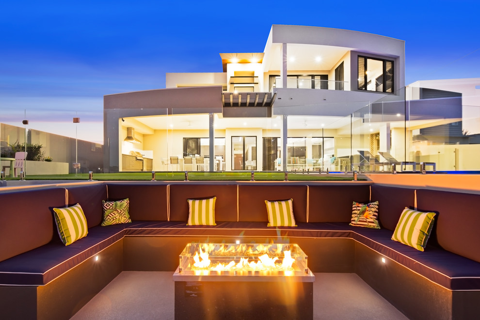 Contemporary patio in Brisbane with a fire feature and no cover.