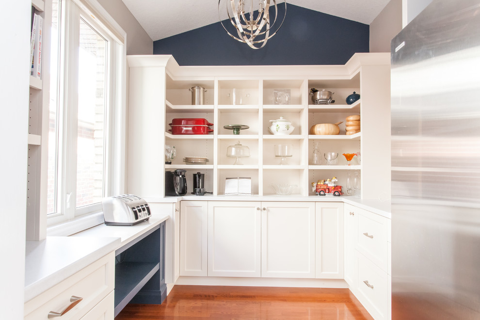 Inspiration for a large transitional u-shaped dark wood floor and brown floor kitchen pantry remodel in Toronto with recessed-panel cabinets, white cabinets, quartz countertops, gray backsplash, stainless steel appliances, an island and white countertops
