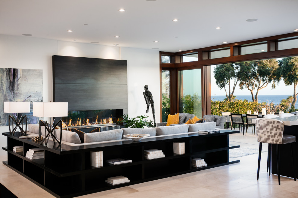 Expansive contemporary formal open concept living room in Orange County with white walls, porcelain floors, a ribbon fireplace, a tile fireplace surround, no tv and beige floor.