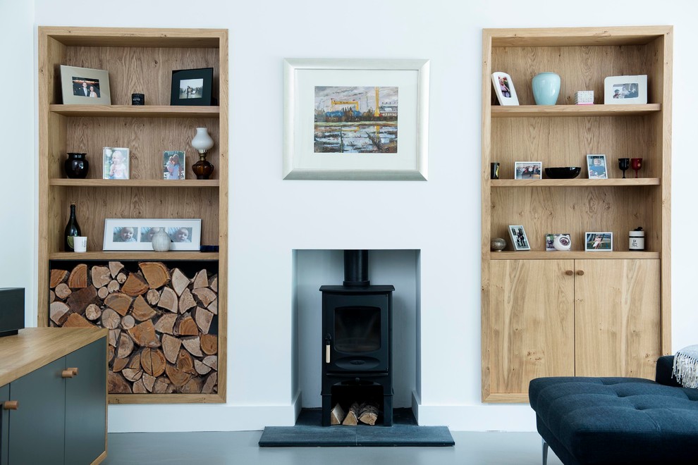 Photo of a contemporary family room in Dublin with white walls, a standard fireplace and no tv.