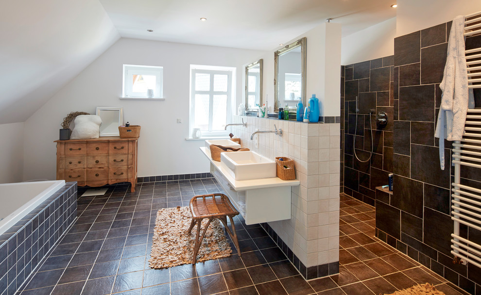 Large country master bathroom in Bremen with open cabinets, a drop-in tub, an open shower, black tile, white walls, a vessel sink, black floor, an open shower, white benchtops and white cabinets.