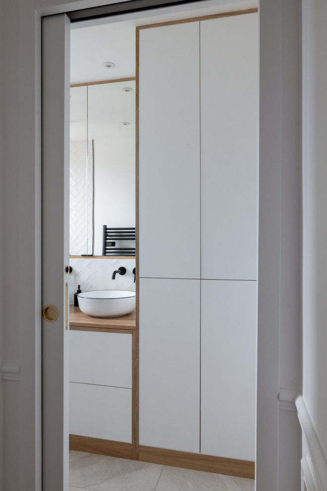 Design ideas for a medium sized scandinavian shower room bathroom in Paris with white cabinets, a walk-in shower, white tiles, matchstick tiles, a built-in sink, laminate worktops, grey floors, brown worktops and double sinks.