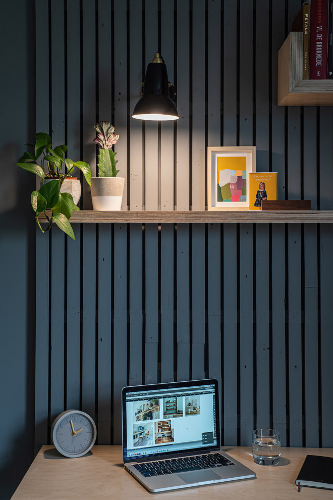 Mittelgroßes Skandinavisches Arbeitszimmer mit Arbeitsplatz, grauer Wandfarbe, Korkboden, Einbau-Schreibtisch, braunem Boden und Wandpaneelen