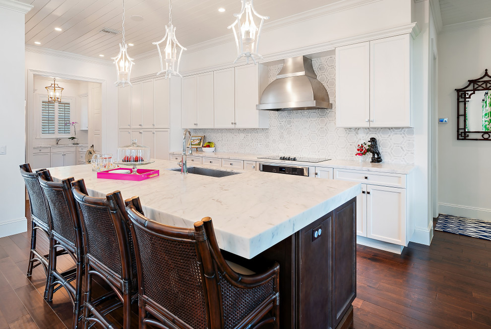 Inspiration for a large transitional l-shaped medium tone wood floor, brown floor and wood ceiling kitchen remodel in Miami with an undermount sink, shaker cabinets, white cabinets, white backsplash, paneled appliances, an island and white countertops
