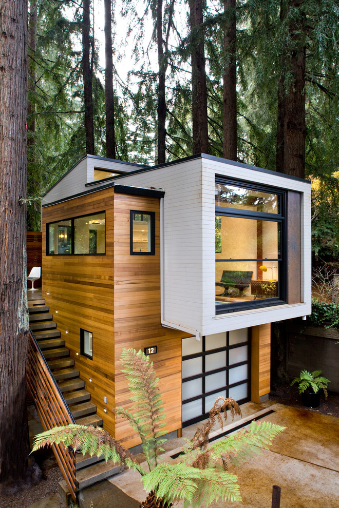 This is an example of a small modern two-storey house exterior in San Francisco with wood siding and a flat roof.