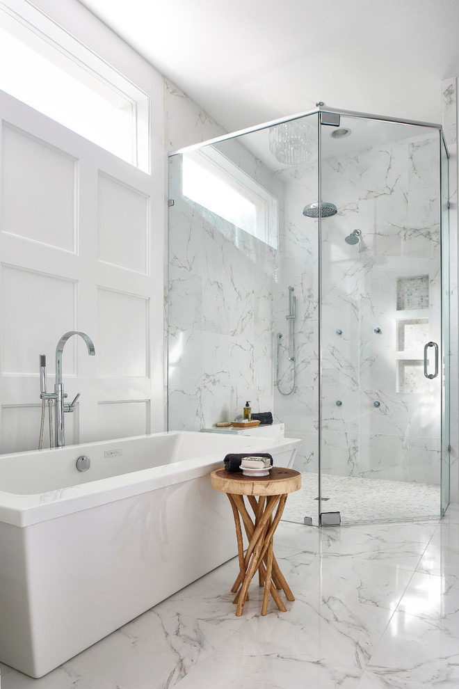 Inspiration for a mid-sized transitional master white tile and porcelain tile porcelain tile freestanding bathtub remodel in Orlando with an undermount sink, shaker cabinets, white cabinets, marble countertops, a one-piece toilet and white walls