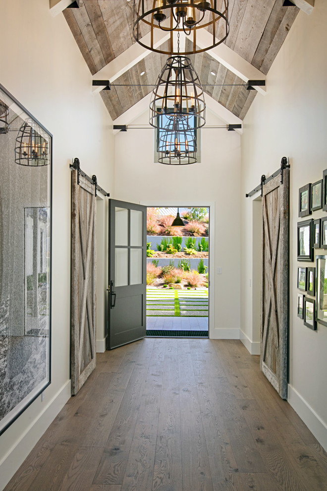 Country entryway in San Diego with beige walls, dark hardwood floors, a single front door, a black front door and brown floor.