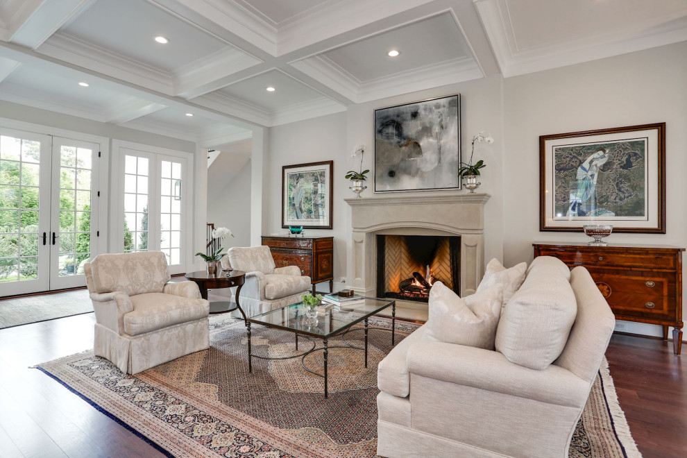 Photo of an expansive family room in DC Metro with grey walls, coffered, dark hardwood floors, a standard fireplace and brown floor.