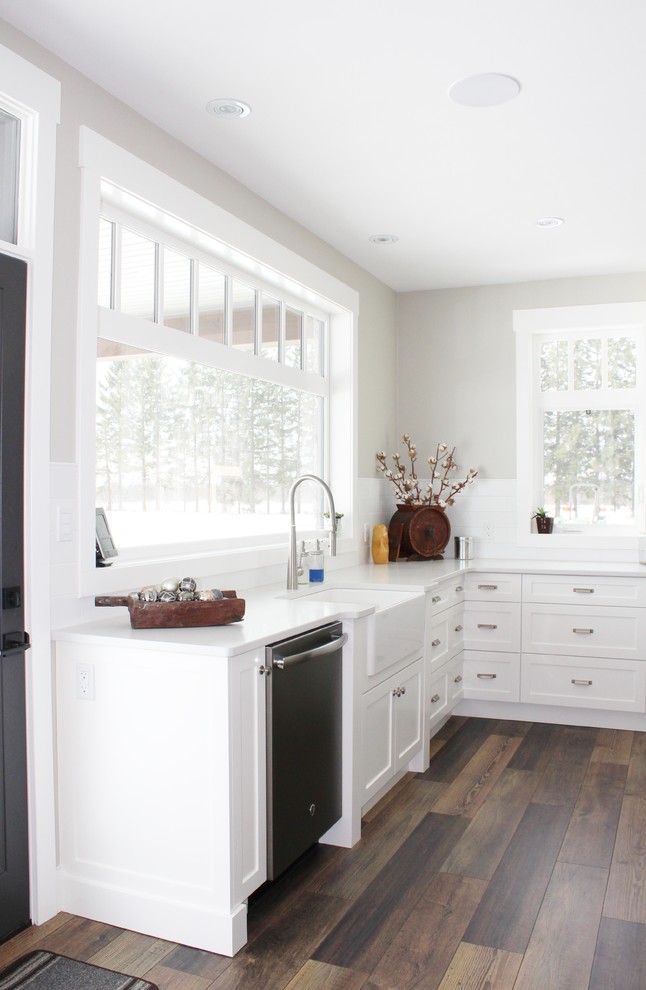 Example of a transitional eat-in kitchen design in Toronto with shaker cabinets, quartz countertops and an island