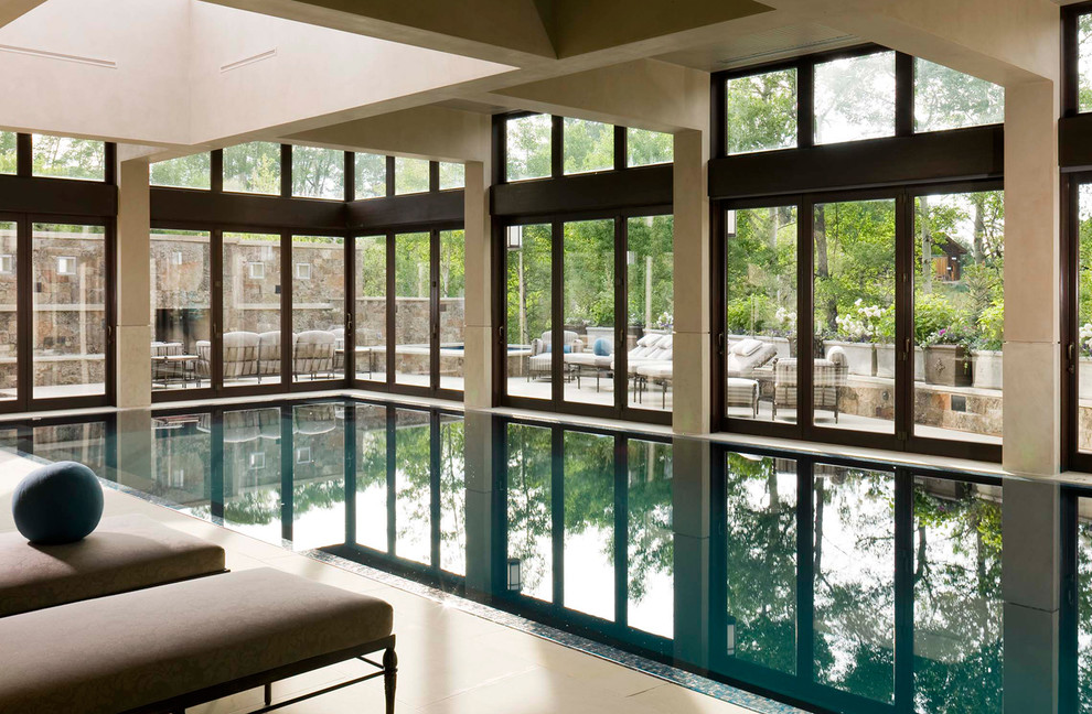 This is an example of a large traditional indoor rectangular lap pool in Denver.