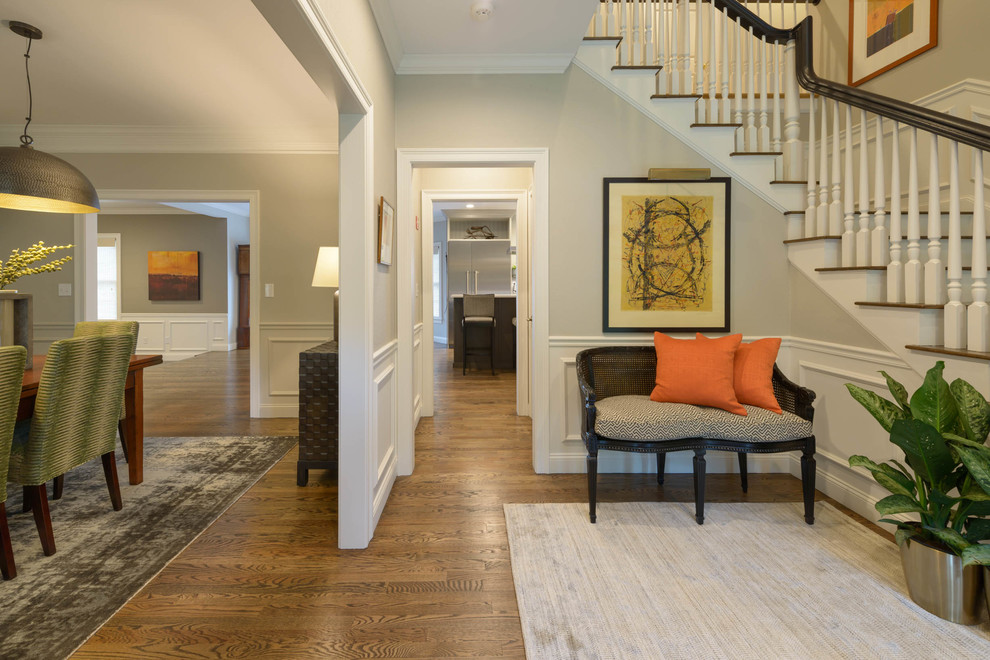 Inspiration for a mid-sized transitional foyer in Boston with beige walls, medium hardwood floors and brown floor.