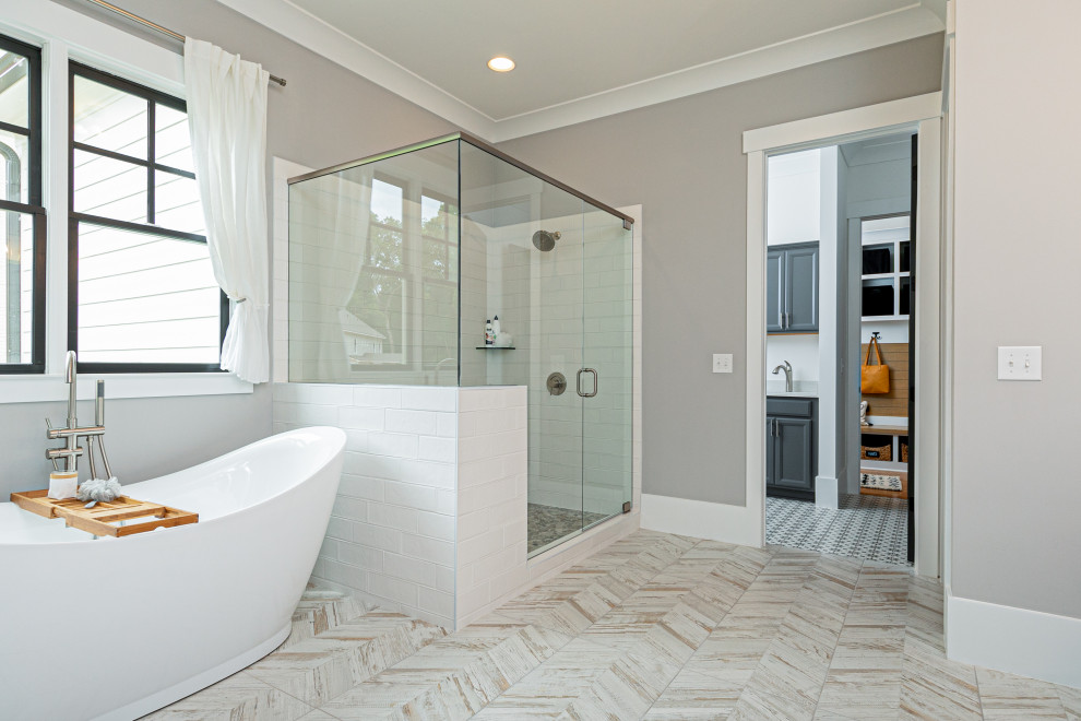 Photo of a mid-sized arts and crafts master bathroom in Atlanta with a freestanding tub, a corner shower, white tile, ceramic tile, grey walls, cement tiles, multi-coloured floor, a hinged shower door, a laundry, shaker cabinets, grey cabinets, quartzite benchtops, white benchtops, a double vanity and a built-in vanity.