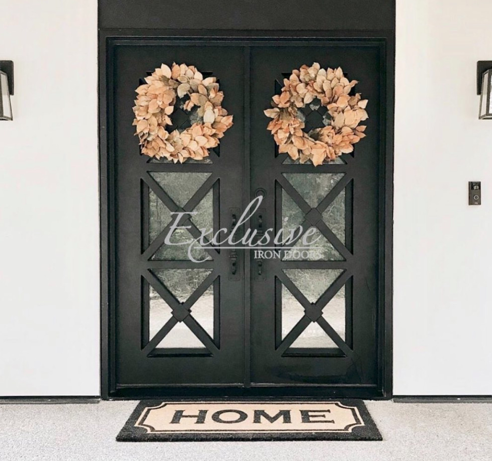 Example of a large front door design in Austin with white walls and a black front door
