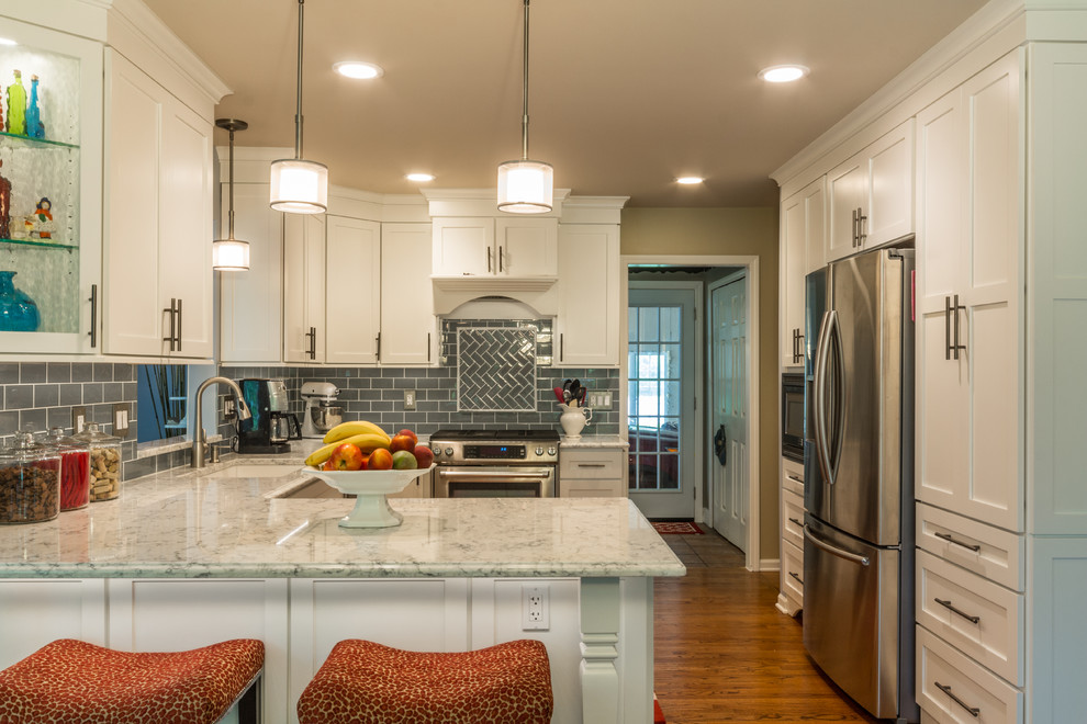 Mid-sized transitional u-shaped medium tone wood floor eat-in kitchen photo in Detroit with an undermount sink, shaker cabinets, white cabinets, quartz countertops, blue backsplash, glass tile backsplash, stainless steel appliances and a peninsula