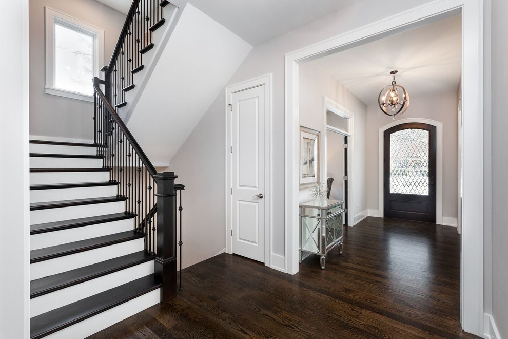 Inspiration for a transitional medium tone wood floor and brown floor foyer remodel in Chicago with gray walls and a brown front door