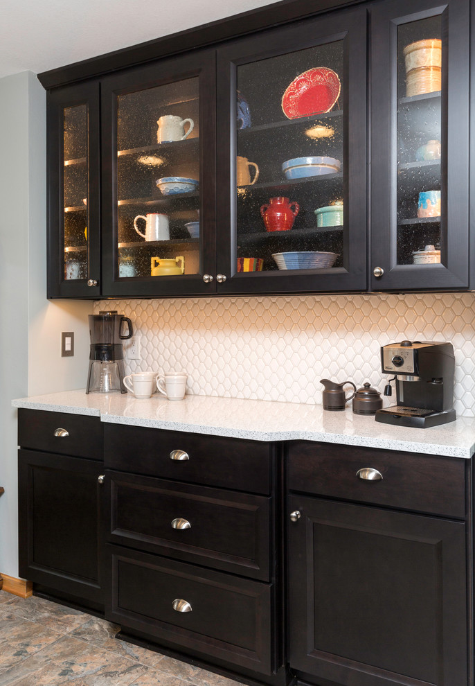 Inspiration for a mid-sized transitional l-shaped vinyl floor and gray floor eat-in kitchen remodel with a farmhouse sink, recessed-panel cabinets, gray cabinets, quartz countertops, white backsplash, ceramic backsplash, stainless steel appliances, no island and white countertops