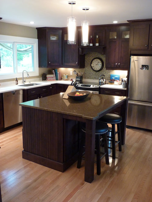Example of a mid-sized transitional l-shaped light wood floor and beige floor open concept kitchen design with an undermount sink, shaker cabinets, dark wood cabinets, granite countertops, multicolored backsplash, mosaic tile backsplash, stainless steel appliances, an island and brown countertops