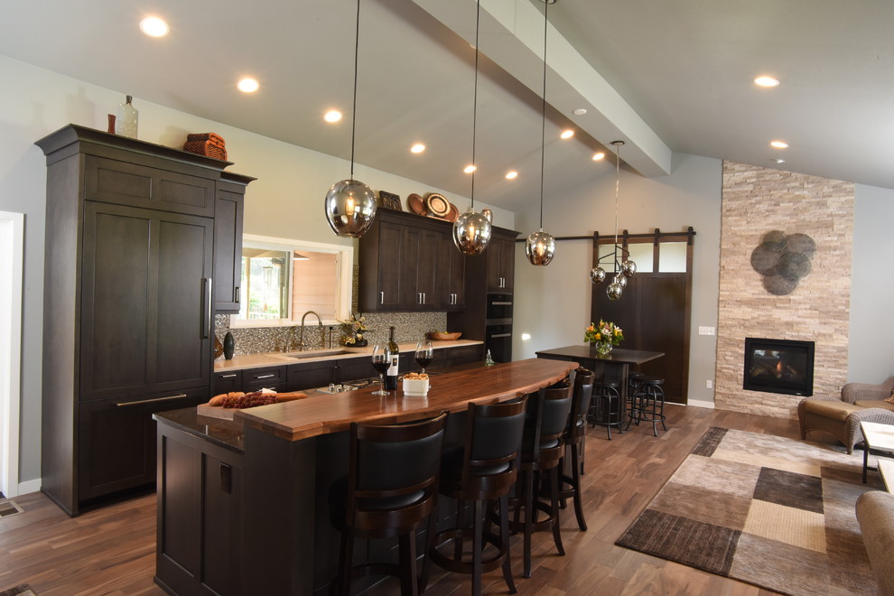 Inspiration for a transitional galley medium tone wood floor kitchen remodel in Seattle with shaker cabinets, dark wood cabinets, quartzite countertops and two islands