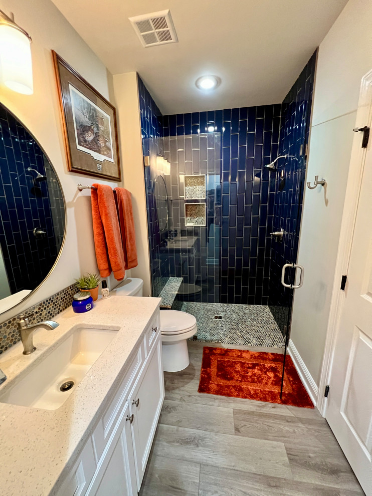 This is an example of a mid-sized transitional bathroom in Other with a curbless shower, blue tile, engineered quartz benchtops and white benchtops.