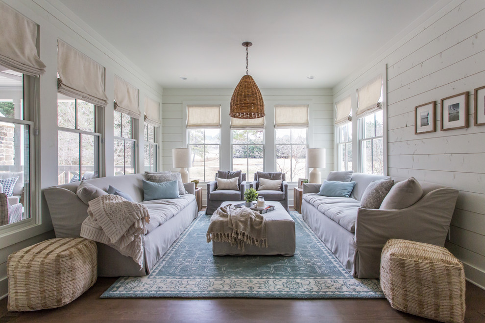 Country living room in Atlanta with white walls, medium hardwood floors and brown floor.