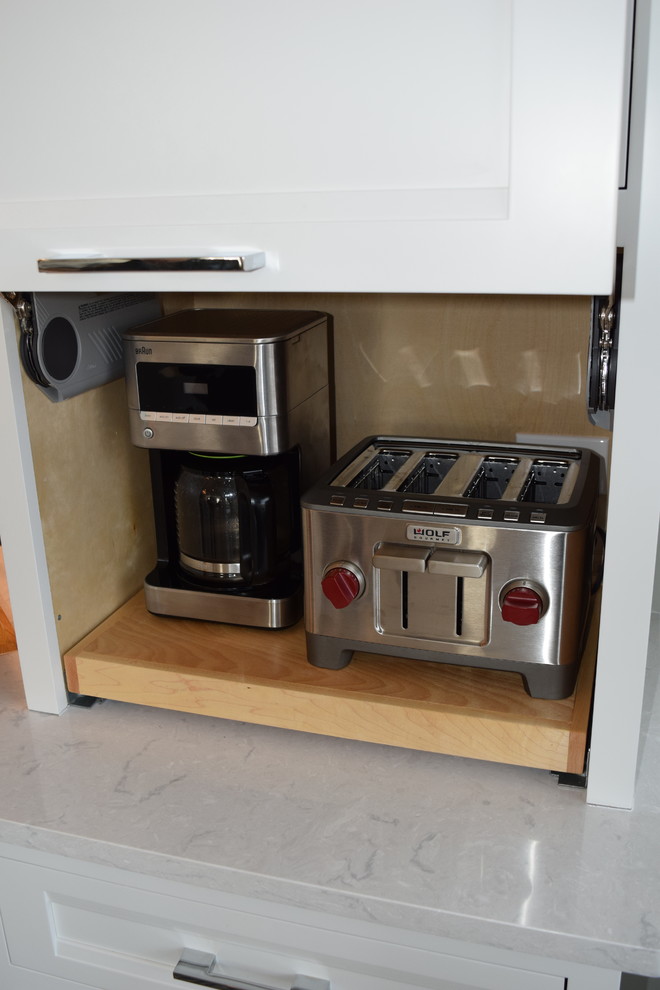 Inspiration for a large transitional l-shaped light wood floor and multicolored floor eat-in kitchen remodel in Chicago with beaded inset cabinets, white cabinets, quartz countertops, black backsplash, ceramic backsplash, stainless steel appliances and an island