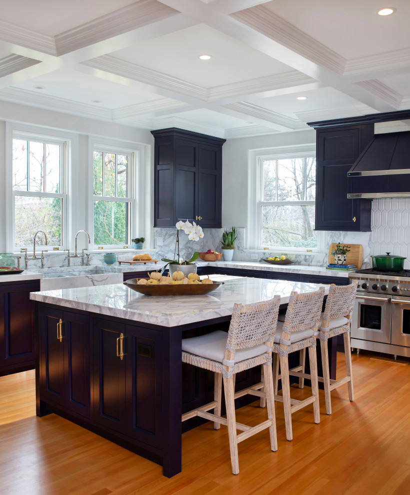 Photo of a mid-sized traditional l-shaped open plan kitchen in Philadelphia with an integrated sink, shaker cabinets, blue cabinets, marble benchtops, white splashback, marble splashback, light hardwood floors, with island, beige floor, multi-coloured benchtop and coffered.