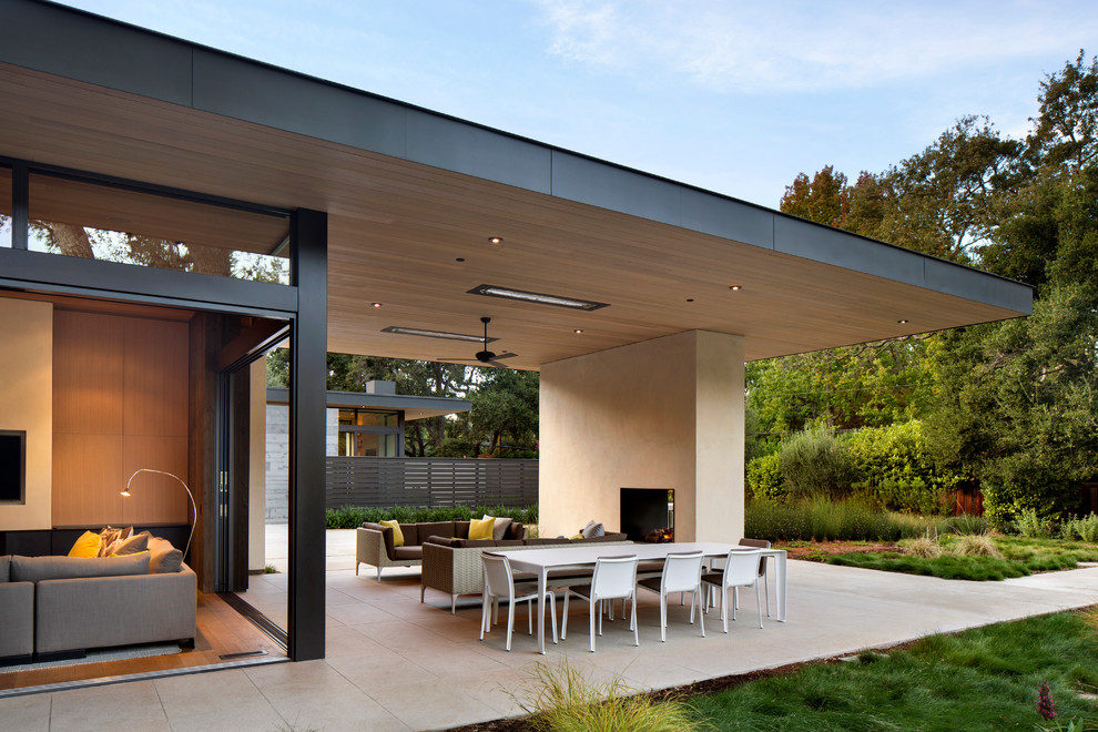 Contemporary backyard patio in San Francisco with a roof extension.