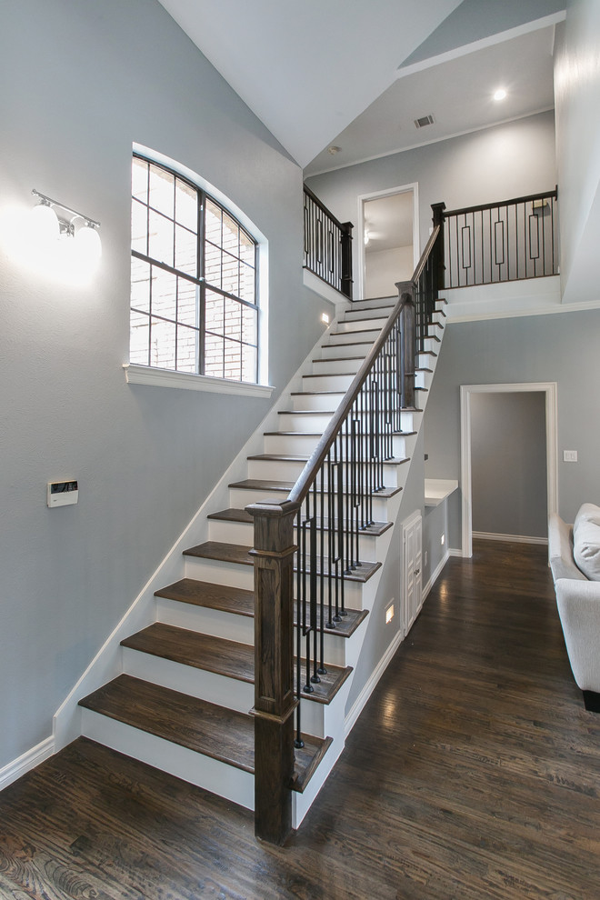Photo of a mid-sized transitional wood straight staircase in Dallas with painted wood risers and mixed railing.