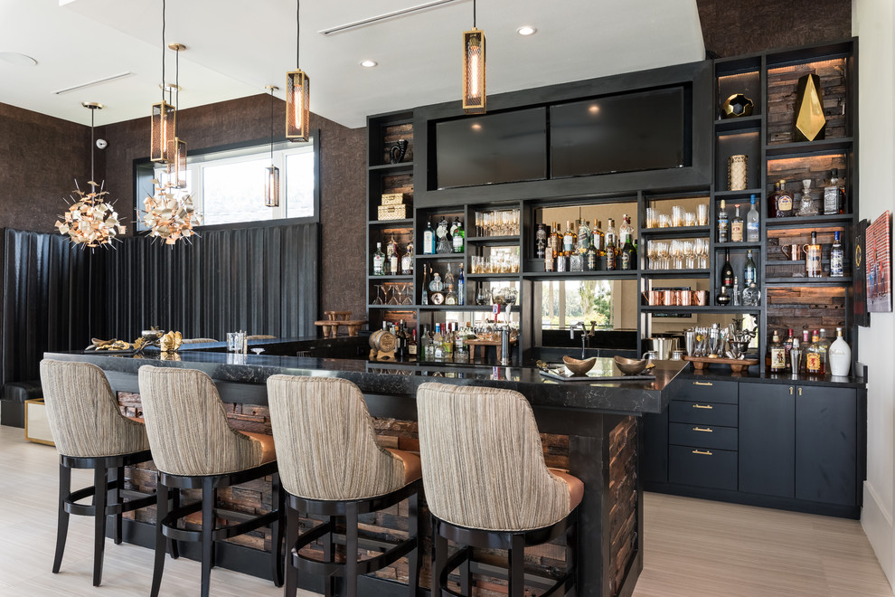 Inspiration for a contemporary seated home bar in Orlando with open cabinets, black cabinets, mirror splashback, beige floor and black benchtop.