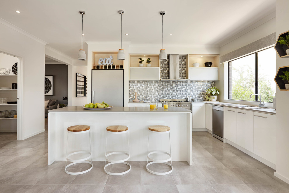 This is an example of a contemporary l-shaped kitchen in Melbourne with flat-panel cabinets, white cabinets, grey splashback, mosaic tile splashback, stainless steel appliances and with island.
