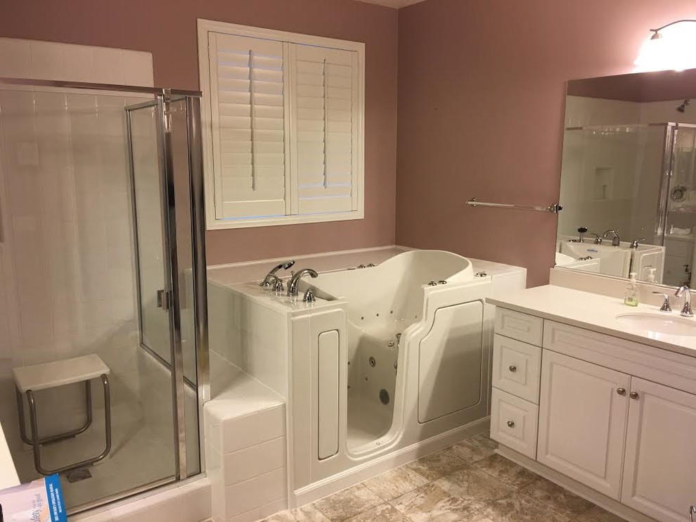 Photo of a mid-sized transitional master bathroom in Orange County with raised-panel cabinets, white cabinets, a corner tub, a corner shower, white tile, porcelain tile, brown walls, porcelain floors, an undermount sink, quartzite benchtops, brown floor and a sliding shower screen.