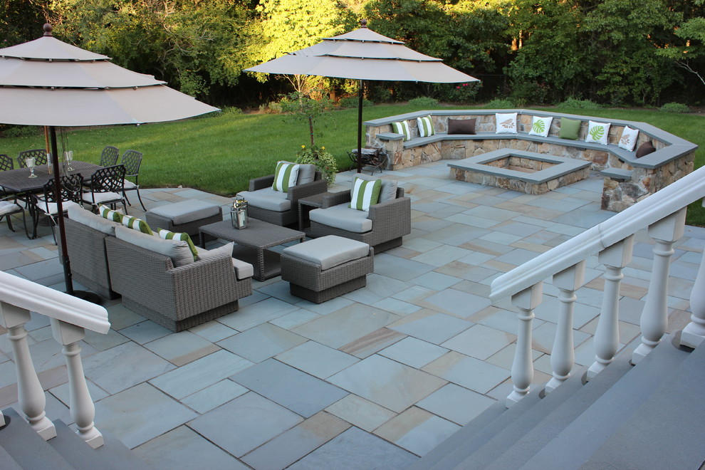Inspiration for a mid-sized traditional backyard patio in New York with a fire feature, concrete pavers and no cover.