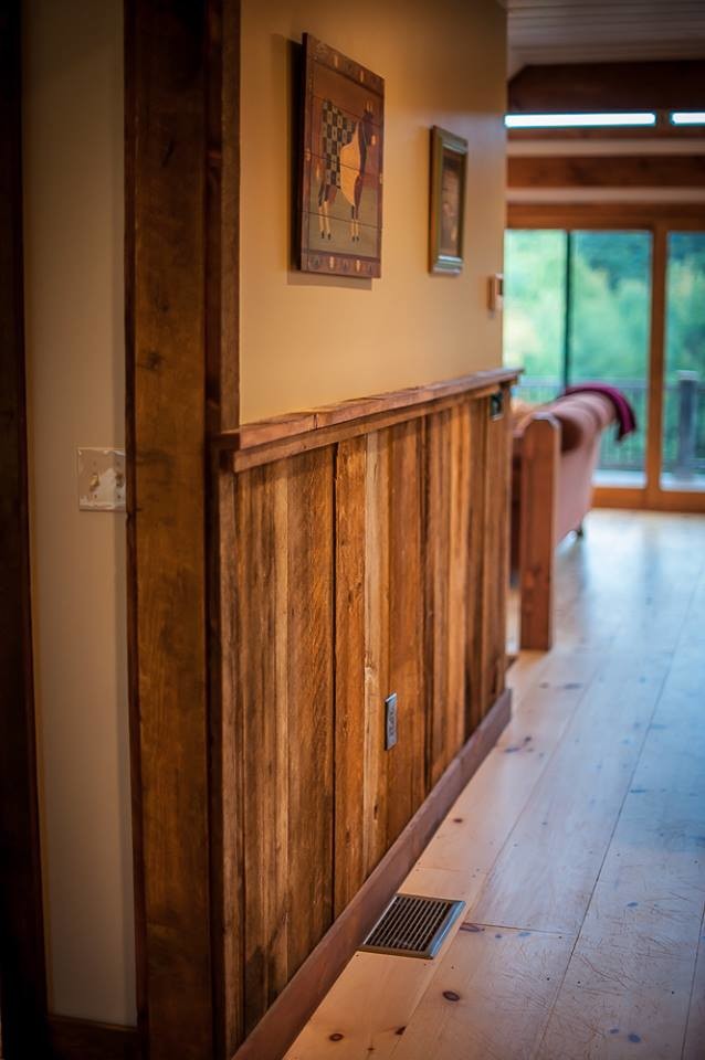 This is an example of a mid-sized country hallway in Manchester with beige walls and light hardwood floors.