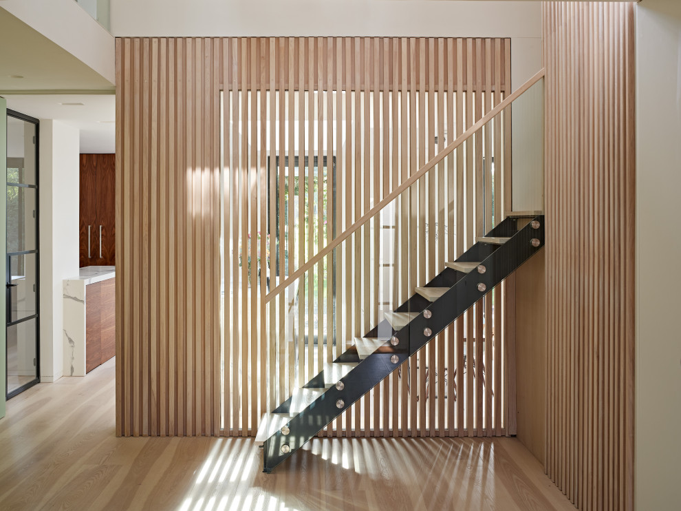 This is an example of a contemporary wood railing staircase in London.