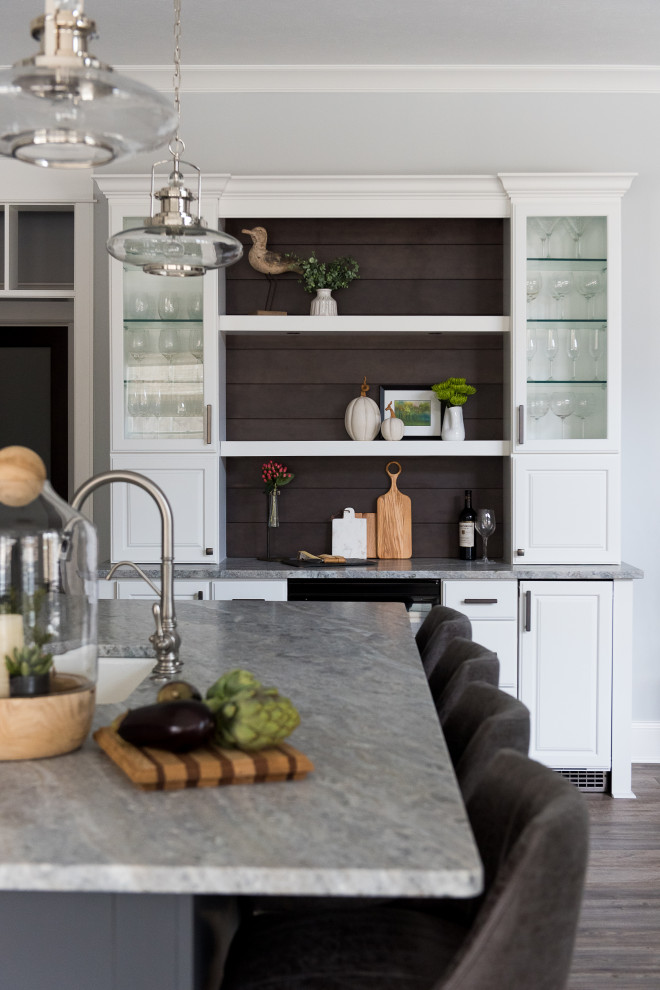 Inspiration for a mid-sized contemporary l-shaped separate kitchen in Indianapolis with an undermount sink, shaker cabinets, white cabinets, grey splashback, stainless steel appliances, dark hardwood floors, with island and beige benchtop.