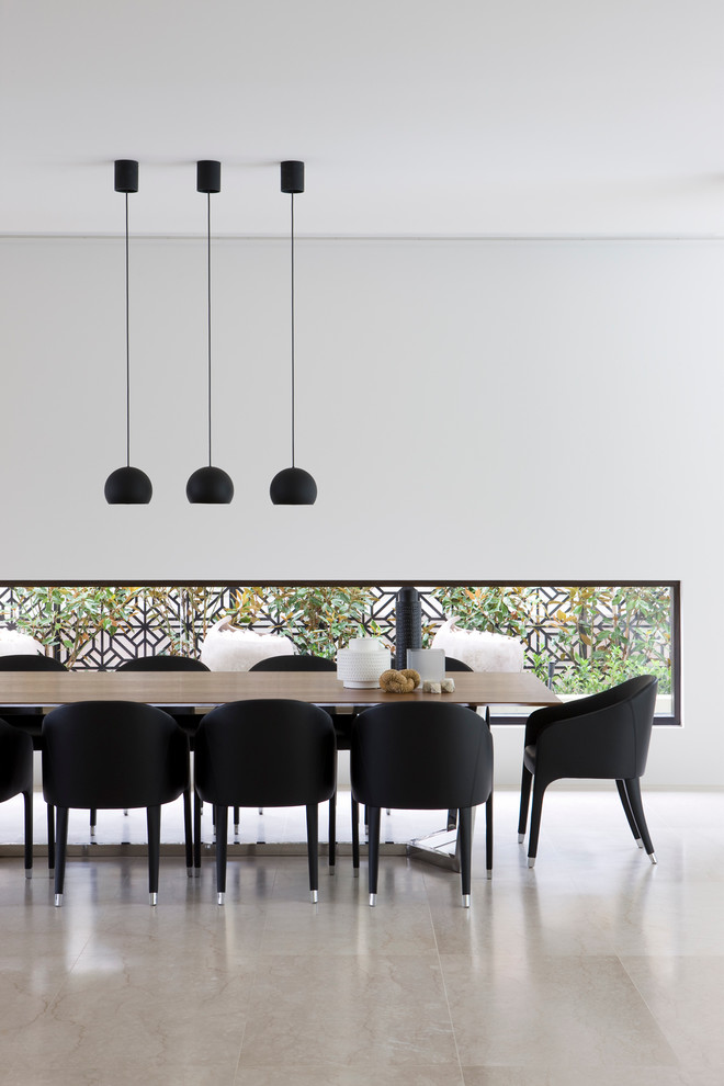 Modern dining room in Melbourne with white walls and no fireplace.