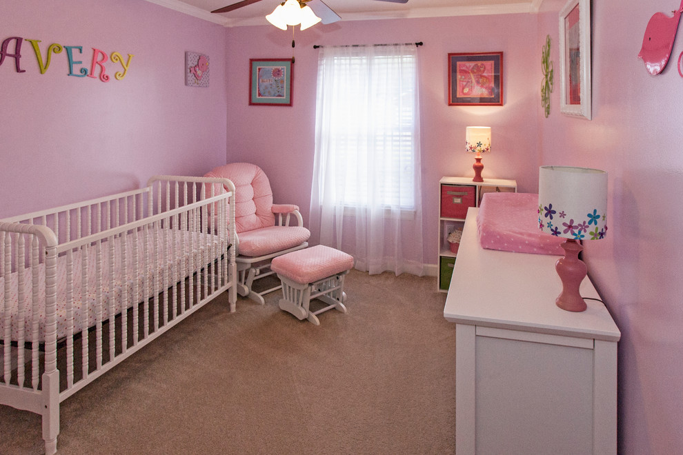 Modern nursery in Miami with pink walls and carpet for girls.