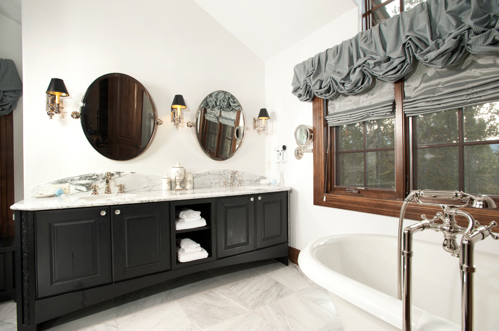 This is an example of a country bathroom in Denver with marble benchtops and black cabinets.